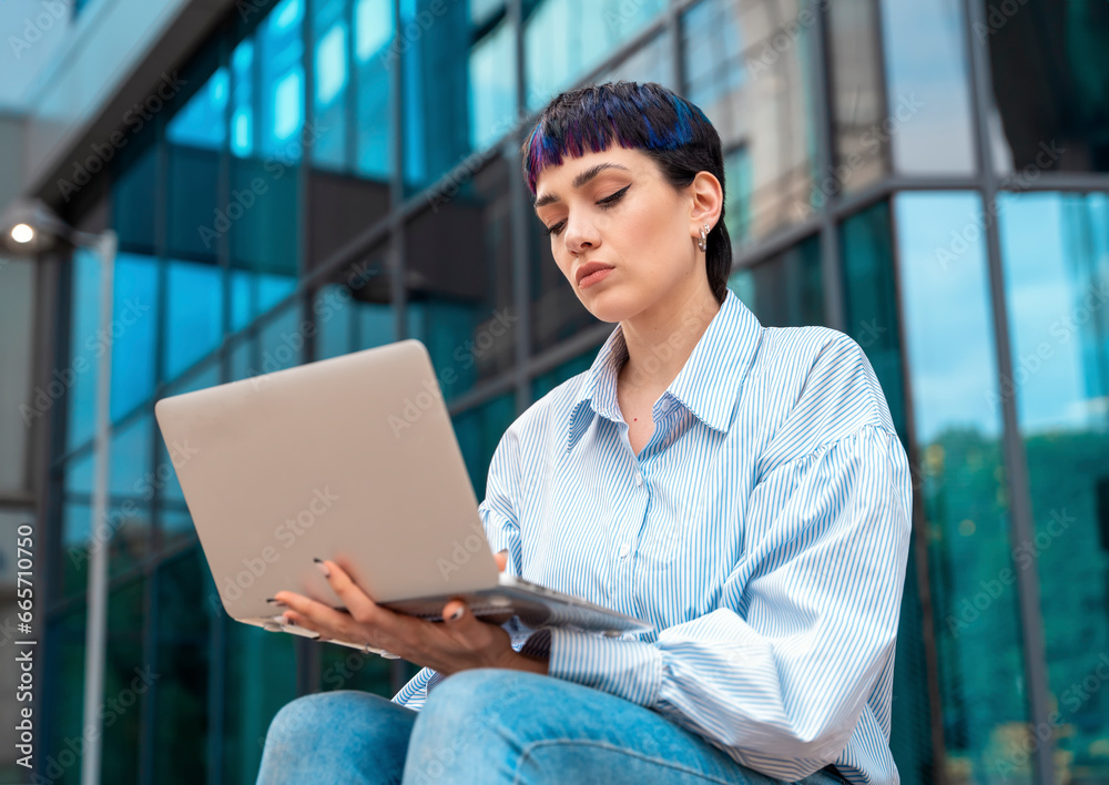 Portrait of a beautiful happy young woman graduate reading e-mail on the laptop and upset about bad news regarding her job application Portrait of a beautiful happy young woman graduate reading e-mail on the laptop and upset about bad news regarding her job application