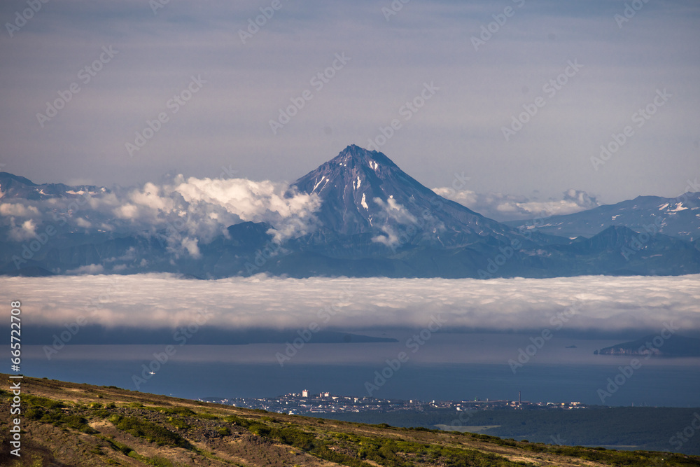 View of the Vilyuchinsky volcano from Avachinskaya Mountain. Natural attractions of the Kamchatka peninsula. View of the Vilyuchinsky volcano from Avachinskaya Mountain. Natural attractions of the Kamchatka peninsula.