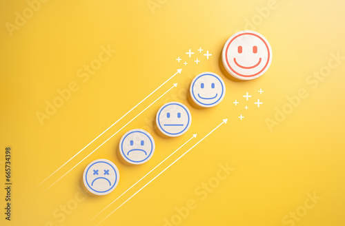 Wooden label with happy normal and sad face icons with arrow trend line for experience survey services and products review concept. Customer show good neutral or negative feedback satisfaction rating.