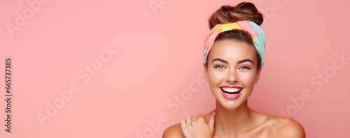 Young beautiful smiling woman in trendy headband on head isolated on flat color background with copy space.  © SnowElf