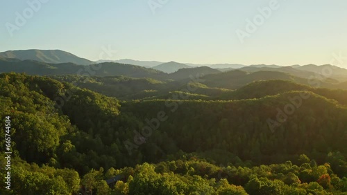 Vast forest hill panorama, Smoky mountains in Tennessee, aerial forward sunrise