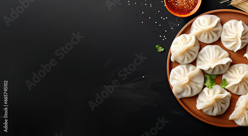 Chinese steamed dumplings. with basil on a black background photo
