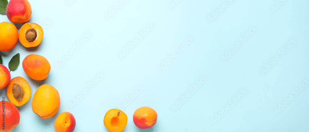 Sweet apricots on light blue background with space for text, top view