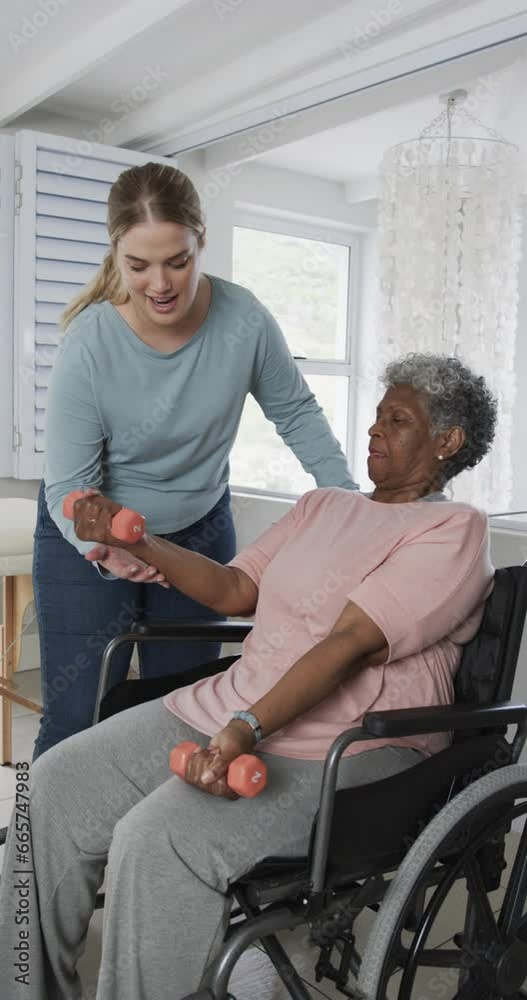 Vertical video of caucasian nurse with senior woman in wheelchair with copy space, slow motion Vertical video of caucasian nurse with senior woman in wheelchair with copy space, slow motion