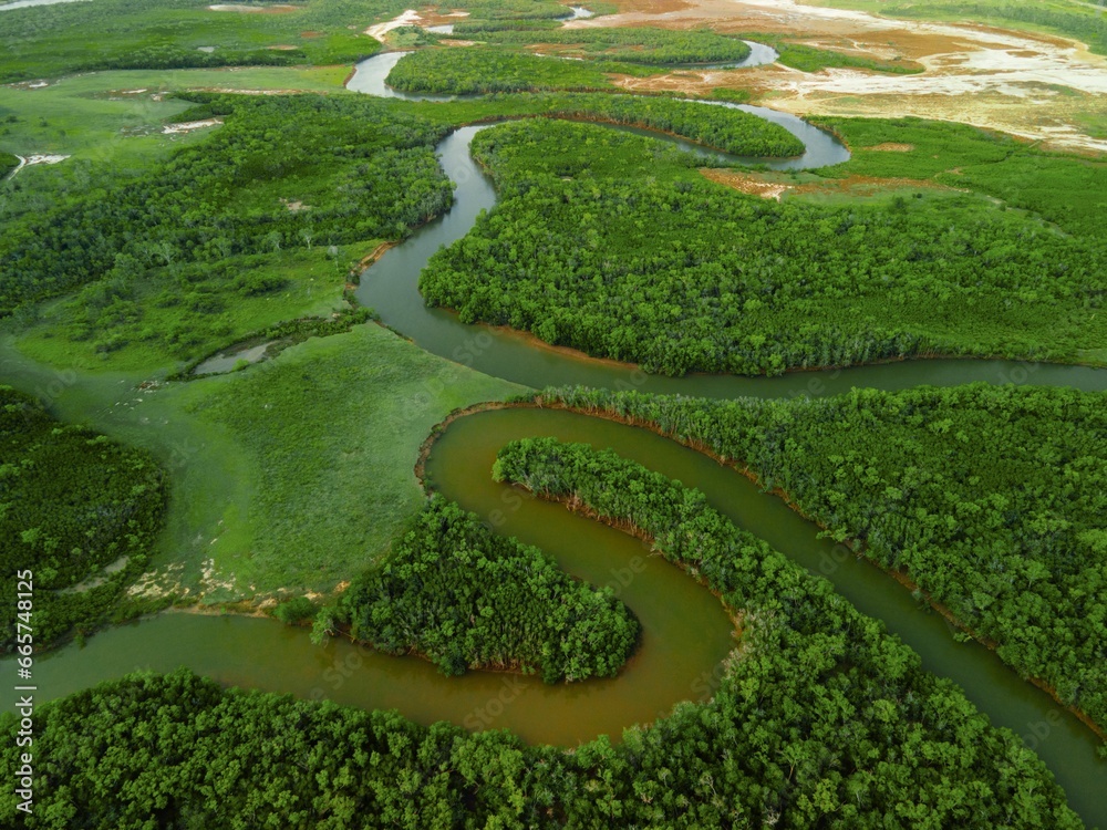 Fototapeta premium Aerial view of a river flowing through a green landscape