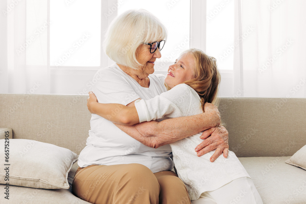 Child woman elderly sofa happy grandmother love girl home granddaughter family old couch Child woman elderly sofa happy grandmother love girl home granddaughter family old couch