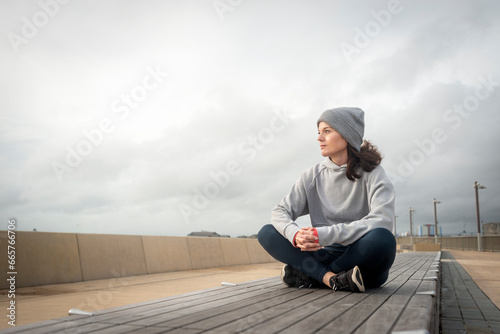 Sporty woman sitting resting after outdoor workout