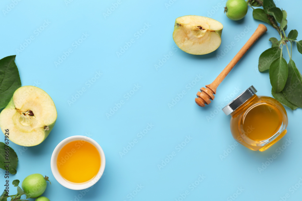 Jar and bowl of honey with apples for Rosh Hashanah celebration (Jewish New Year) on blue background Jar and bowl of honey with apples for Rosh Hashanah celebration (Jewish New Year) on blue background
