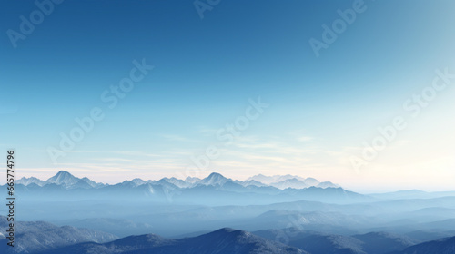 A mountain range  with peaks of various heights and shapes  looms on the horizon The sky is a brilliant  clear blue  and the sun is setting in the distance