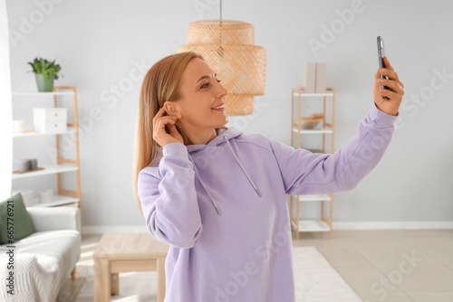 Mature woman in hoodie taki...
