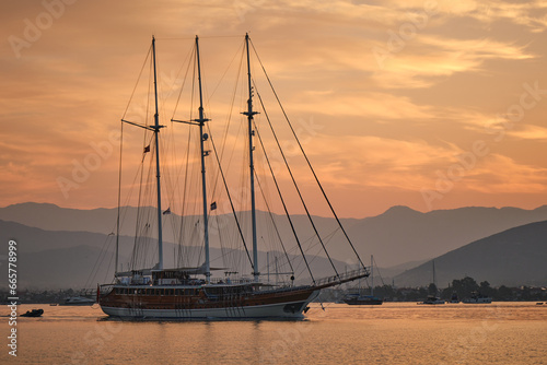 Sailing yacht on the open sea at sunset.