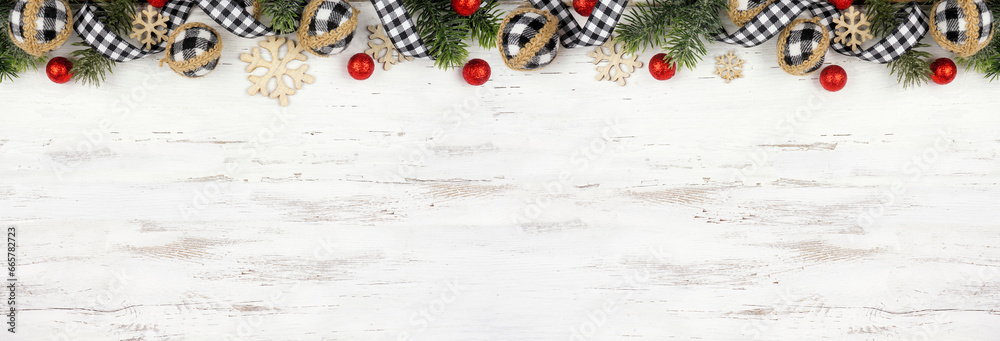 Christmas top border of white and black gingham ribbon, baubles and branches. Above view on a white wood banner background. Copy space. - obrazy, fototapety, plakaty 