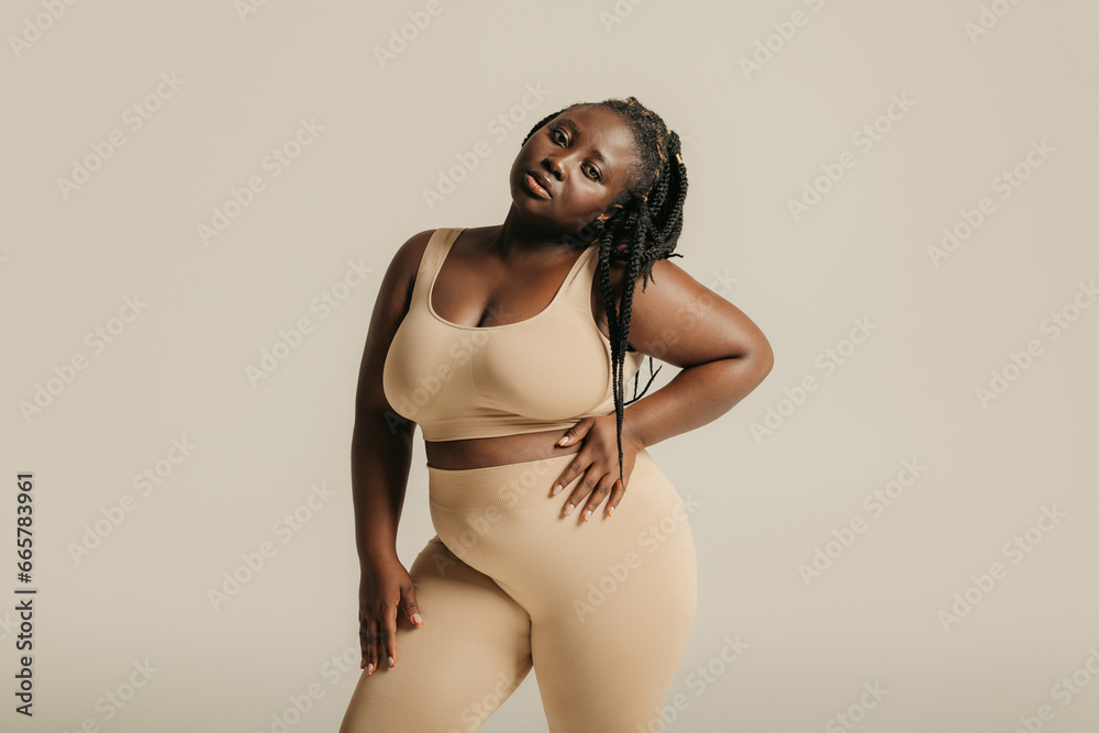 © gstockstudio - Beautiful young curvy woman in underwear looking confident in her body on studio background