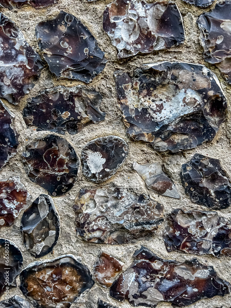 An example of the use of local flint stone and brick in wall masonry. Selective focus 