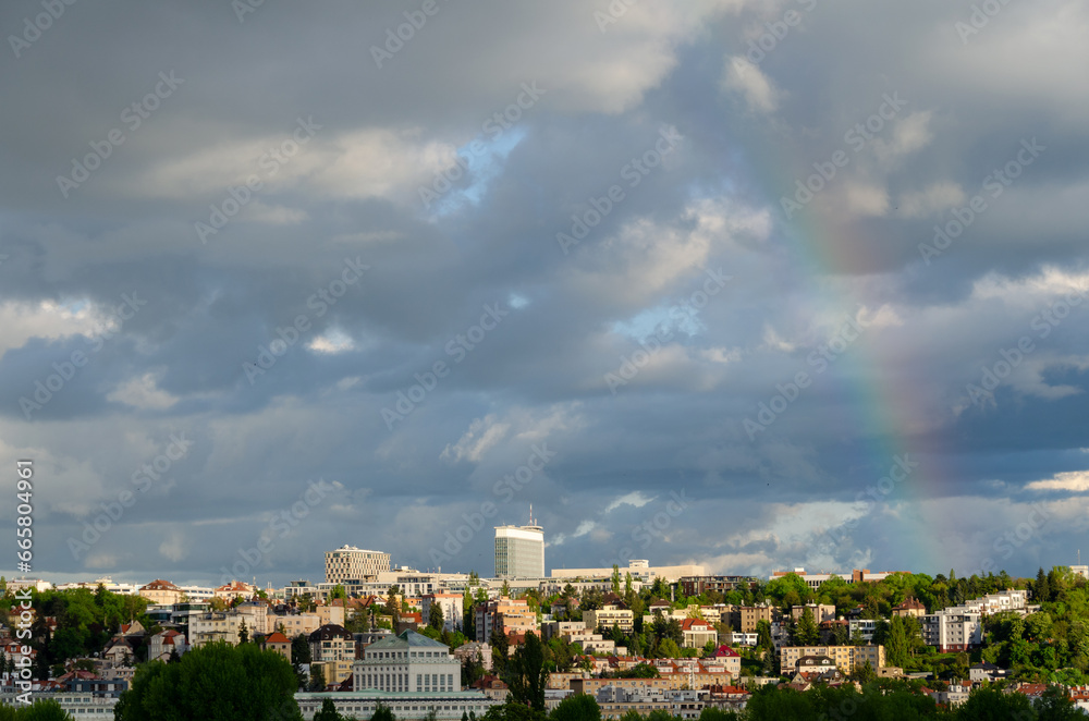 Cloudy sky and a rainbow over Pankrac, a modern district with skyscrapers in Prague, Czech Republic