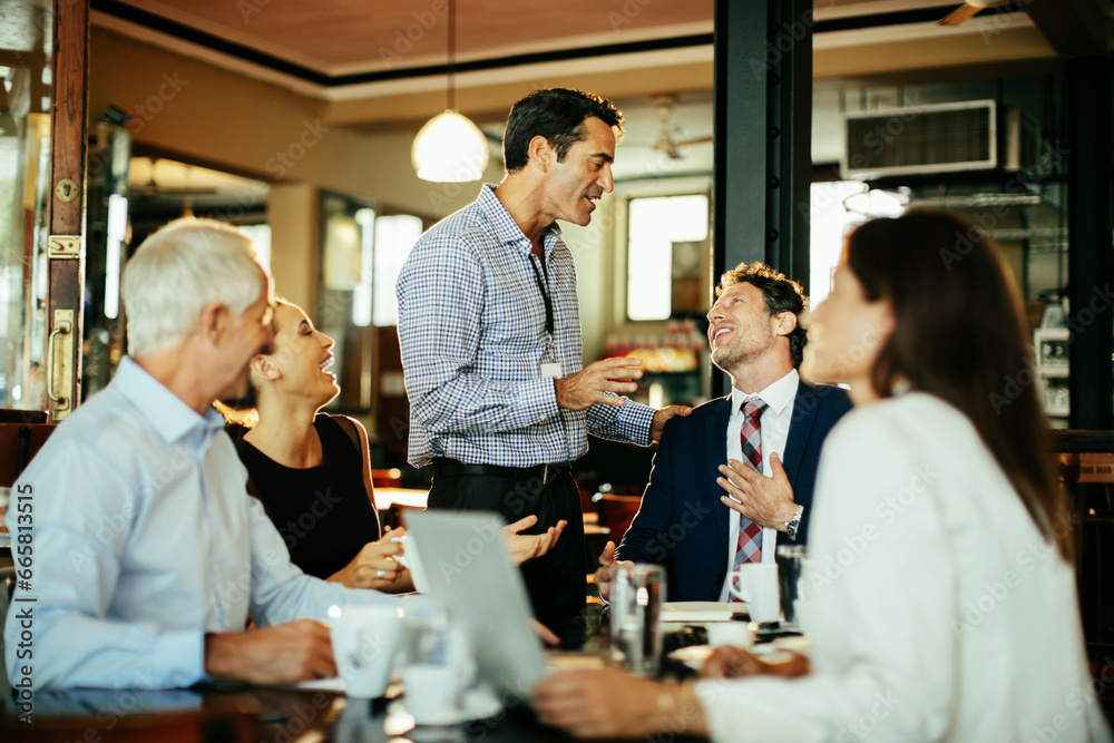 Diverse business people having a meeting in a cafe Diverse business people having a meeting in a cafe