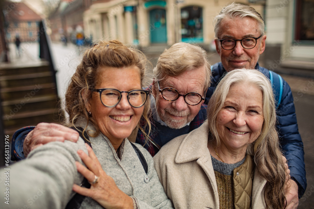 Portrait of a group of senior friends taking a picture in the city on vacation Portrait of a group of senior friends taking a picture in the city on vacation