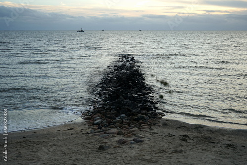 Küstenschutz mit Wellenbrecher am Deich im Herbst in Büsum im Kreis Dithmarschen an der Küste der Nordsee an der Nordsee in Nordfriesland in Schleswig-Holstein photo