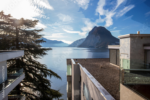 View on lkae Lugano with part of residential building (4 storey) on the shore of Lugano lake photo