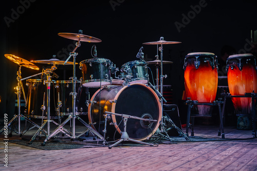 Drums and drum set. Beautiful blue and red background, with rays of light. Beautiful special effects of smoke and lighting. Musical instrument. The concept of music.  © Raivo