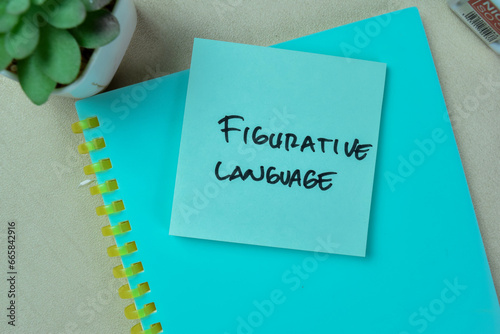 Concept of Figurative Language write on sticky notes isolated on Wooden Table. photo