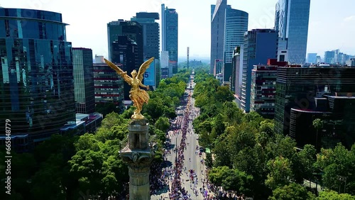 Aerial view from Mexico angel de la independencia monument in a festival dia de muertos parade, alebrijes art in reforma street