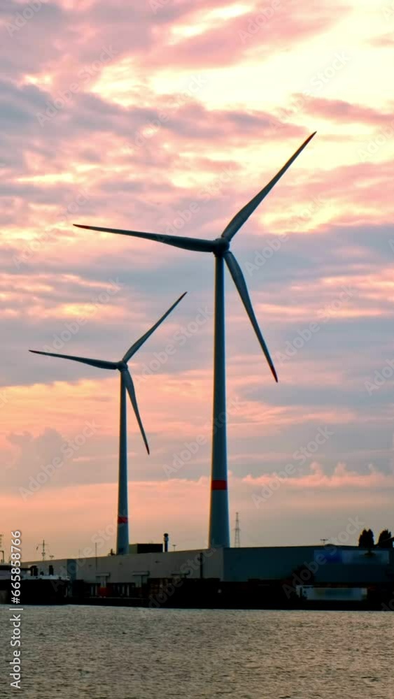 Wind turbines in Antwerp port on sunset. Antwerp, Belgium Wind turbines in Antwerp port on sunset. Antwerp, Belgium