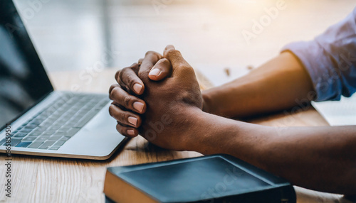 hands together in prayer for god blessing to wish to have a better life man hands praying to god with the bible on his laptop believe in goodness spirituality and religion and bible prayer online photo