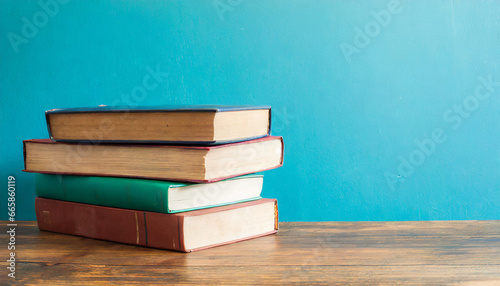 a stack of books on a table next to a blue wall in the style of retro vintage