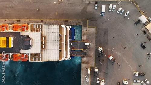 Ferry boat with Cars and Tourists arriving to Rhodes port on board a daily ferry cruise  photo