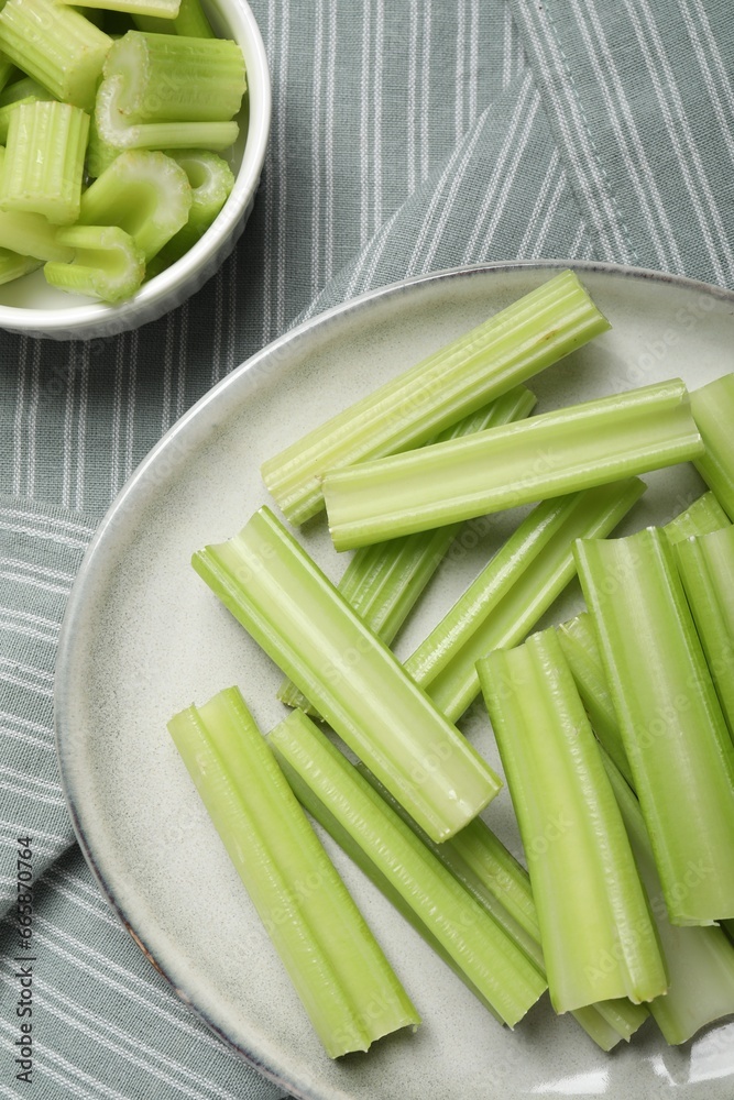 Fresh green cut celery on striped tablecloth, flat lay Fresh green cut celery on striped tablecloth, flat lay
