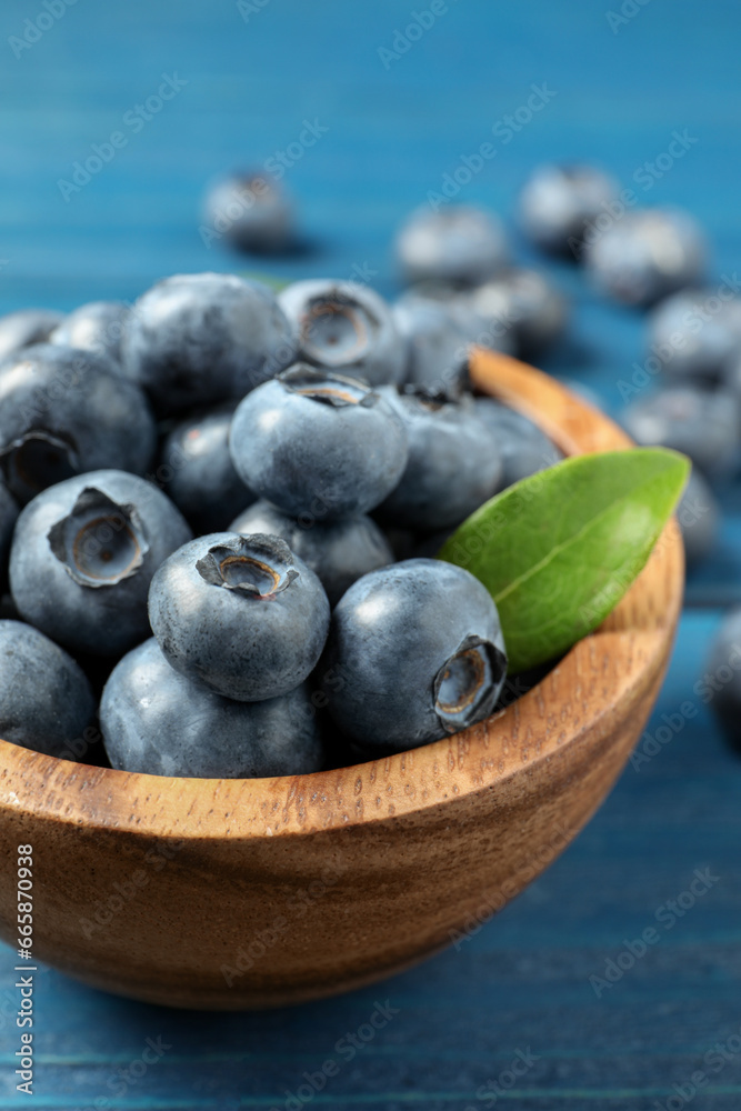 Bowl of fresh tasty blueberries on blue wooden table, closeup Bowl of fresh tasty blueberries on blue wooden table, closeup