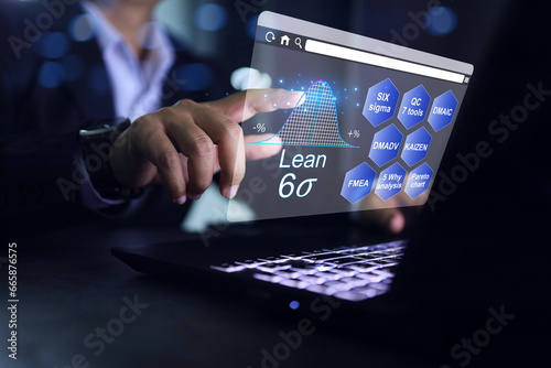 Businessman with six sigma tools analyzes data and finds ways to increase productivity and reduce waste on a notebook computer screen work desktop in office photo