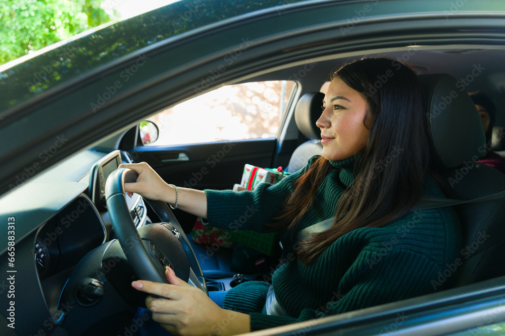 Attractive woman enjoying driving her car