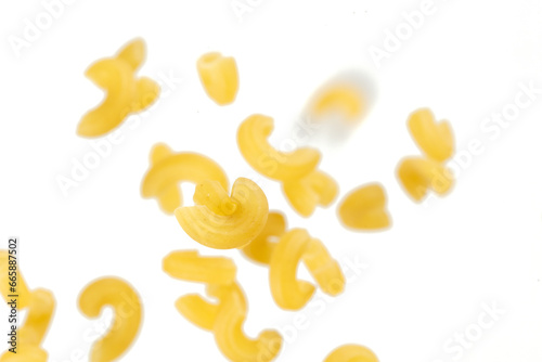 Macaroni flying explosion  yellow macaronis pasta float explode  abstract cloud fly. Curved macaroni pasta splash throwing in Air. White background Isolated freeze motion selective focus
