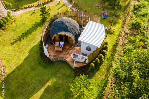 a couple of men and women camping in the mountains of Northern Thailand during vacation. Outdoor bathroom, and bathtub during sunset in the mountains at an igloo hut