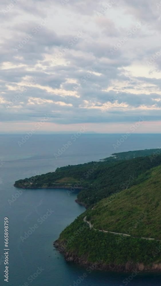 Tropical mountain with cliff and highway in coastline. Camiguin Island. Philippines. Vertical video. Tropical mountain with cliff and highway in coastline. Camiguin Island. Philippines. Vertical video.