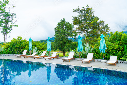 pool bed around swimming pool with mountain hill background © topntp