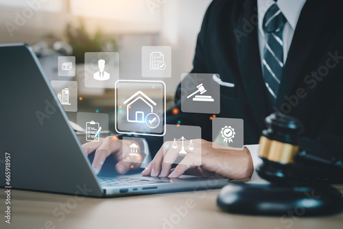 business man uses a computer and house law icons on the dashboard screen to study or search law home, building, or estate and consult a lawyer online tax house photo