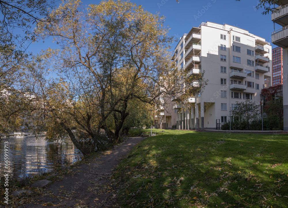 Waterfront apartment buildings at the canal Karlbergskanalen, a sunny colorful autumn day in Stockholm