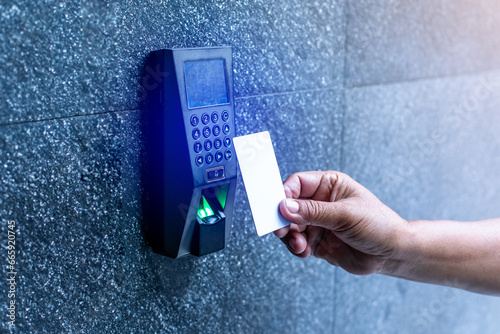 Staff holding a key card to lock and unlock door at home or condominium. using electronic card key for access. electronic key and finger scan access control system to unlock doors photo