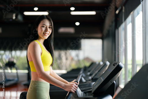 Young Asian Woman Running on Treadmill - Fitness Gym Exercise