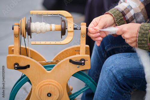 The spinning process involves twisting the fibers of the wool together to create a strong and durable thread for various textile applications.