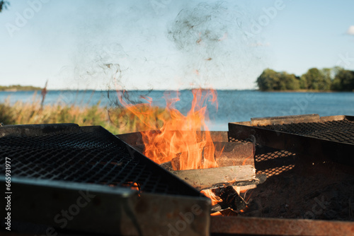 bright flaming fire in a fire pit by the beach in Sweden