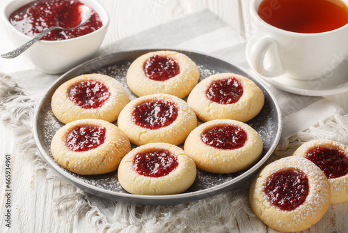 Obraz na płótnie Hallongrottor or Swedish rapsberry caves jam cookies closeup on the plate on the white wooden table. Horizontal w salonie