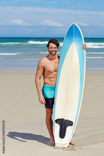 Beach portrait, surfboard and sports man on holiday, vacation or Spain getaway for nature, freedom or natural outdoor wellness. Surfboard, summer and face of relax surfer on tropical island sand