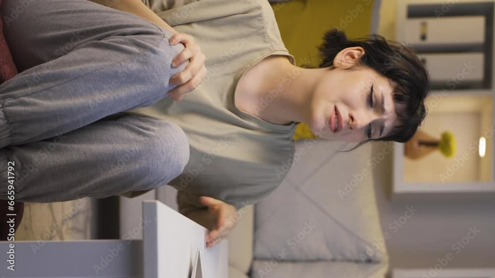 Vertical video of Exhausted young woman at home at night. Helpless facial expression. Vertical video of Exhausted young woman at home at night. Helpless facial expression.