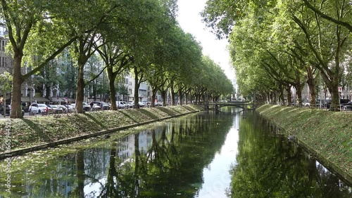 View of the Konigsallee's eastern side across the canal on a sunny day in Dusseldorf, Germany photo