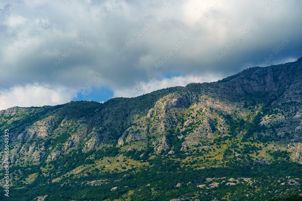 beautiful mountains and cloudy sky, summer landscape, clouds, forest on the hillsides beautiful mountains and cloudy sky, summer landscape, clouds, forest on the hillsides