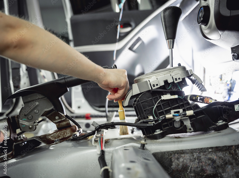 Worker make dry cleaning the car interior using a special brush with foam Worker make dry cleaning the car interior using a special brush with foam